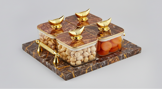 Decorative marble and gold container with two jars on a light gray background